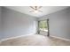 Simple bedroom with gray walls, ceiling fan, and a window with natural light at 1851 Grand Keahl Ln, Deltona, FL 32738