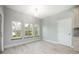 Light-filled dining room featuring three large windows and wood-look flooring at 1851 Grand Keahl Ln, Deltona, FL 32738