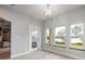 Dining space with tile flooring, three windows, and glass door leading to the outside at 1851 Grand Keahl Ln, Deltona, FL 32738