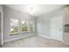 Bright dining area featuring wood floors, three windows, and a stylish chandelier at 1851 Grand Keahl Ln, Deltona, FL 32738