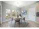 Cozy dining area with a round table and natural light from the three windows at 1851 Grand Keahl Ln, Deltona, FL 32738