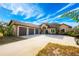 Charming home with a three-car garage and well-manicured lawn and landscaping at 1851 Grand Keahl Ln, Deltona, FL 32738