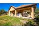 Backyard features a patio, a grassy lawn, and an abundance of trees at 1851 Grand Keahl Ln, Deltona, FL 32738