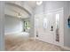 Inviting foyer features tile floors, white door with glass, and view of dining room at 1851 Grand Keahl Ln, Deltona, FL 32738