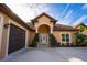 Inviting front exterior showcasing an arched entryway, well-maintained landscaping and two-car garage at 1851 Grand Keahl Ln, Deltona, FL 32738