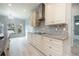 Bright kitchen featuring custom cabinets, granite countertops, and stainless steel appliances at 1851 Grand Keahl Ln, Deltona, FL 32738
