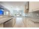 Bright kitchen featuring custom cabinets, granite countertops, and stainless steel appliances at 1851 Grand Keahl Ln, Deltona, FL 32738