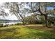 Picturesque lake view framed by mature trees and lush greenery creates a tranquil and scenic backdrop at 1851 Grand Keahl Ln, Deltona, FL 32738