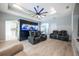 Relaxing living room with a large aquarium, two black leather recliners, and wood-look flooring at 1851 Grand Keahl Ln, Deltona, FL 32738