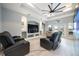 Modern living room with large TV, coffered ceilings, ceiling fan, and comfortable seating at 1851 Grand Keahl Ln, Deltona, FL 32738
