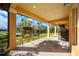 Covered patio with view of backyard and lake, potted plants, and seating area at 1851 Grand Keahl Ln, Deltona, FL 32738