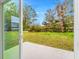 View of backyard through sliding glass door at 3065 Jon Jon Ct, Orlando, FL 32822