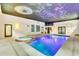 Indoor pool and spa with a unique painted ceiling at 3141 Oak Alley Dr, Apopka, FL 32703