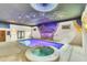 Indoor pool and spa with a unique painted ceiling at 3141 Oak Alley Dr, Apopka, FL 32703