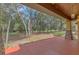 Covered porch overlooking a wooded backyard at 3141 Oak Alley Dr, Apopka, FL 32703