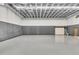 Empty studio space with roll-up door at 3141 Oak Alley Dr, Apopka, FL 32703