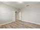 Bright bedroom with wood-look flooring and access to hallway at 3464 Julius Estates Blvd, Winter Haven, FL 33881