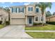 Two-story house with blue accents and a two-car garage at 3464 Julius Estates Blvd, Winter Haven, FL 33881