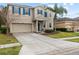 Tan two-story house with blue front door and palm trees at 3464 Julius Estates Blvd, Winter Haven, FL 33881