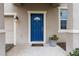 Blue front door entry with a planter and garage to the left at 3464 Julius Estates Blvd, Winter Haven, FL 33881