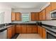 Kitchen with wood cabinets, granite counters, and a double sink at 3464 Julius Estates Blvd, Winter Haven, FL 33881