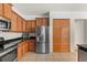 Kitchen with stainless steel refrigerator and wood cabinets at 3464 Julius Estates Blvd, Winter Haven, FL 33881