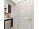 Small laundry room with mini-fridge and shelving at 3464 Julius Estates Blvd, Winter Haven, FL 33881