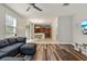 Living room with gray sectional sofa and wood-look floors at 3464 Julius Estates Blvd, Winter Haven, FL 33881