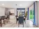 Open dining room with wooden table and gray chairs, near kitchen at 3516 Sandalwood Isle Way, Ocoee, FL 34761