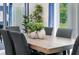 Elegant dining room features a light wood table and gray chairs at 3540 Sandalwood Isle Way, Ocoee, FL 34761