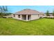 Single-story home with a covered patio and landscaped yard at 3540 Sandalwood Isle Way, Ocoee, FL 34761