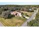 Aerial view of home with expansive lawn, mature trees, and private surroundings at 38207 Sabal Way, Umatilla, FL 32784