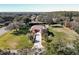 An aerial view of the property showcasing the spacious lawn, mature trees, and long driveway at 38207 Sabal Way, Umatilla, FL 32784