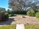 Backyard featuring crushed rock, small fire pit, lights, and tidy landscaping at 38207 Sabal Way, Umatilla, FL 32784