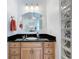 Bathroom vanity featuring a large oval mirror, granite countertop, and ample cabinet space at 38207 Sabal Way, Umatilla, FL 32784