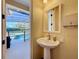 Bathroom featuring a pedestal sink and view to the pool area at 38207 Sabal Way, Umatilla, FL 32784