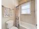 Bathroom with decorative shower curtain and matching towels, and white tiled walls at 38207 Sabal Way, Umatilla, FL 32784