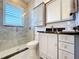 Modern bathroom with glass shower and gray cabinets at 38207 Sabal Way, Umatilla, FL 32784