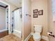 Bathroom featuring tiled floors, framed art, a toilet, and a bathtub with shower at 38207 Sabal Way, Umatilla, FL 32784