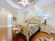 Bedroom featuring a tropically styled bed, hardwood floors, and bright natural lighting at 38207 Sabal Way, Umatilla, FL 32784