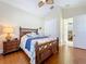 Bright bedroom with decorative ceiling fan, wood floors, and a large decorative wood bed frame at 38207 Sabal Way, Umatilla, FL 32784