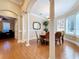 Formal dining area showcasing wood floors, white columns and accents, and views into the office area at 38207 Sabal Way, Umatilla, FL 32784