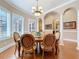 Formal dining room showing hardwood floors, arched doorways, columns and shuttered windows at 38207 Sabal Way, Umatilla, FL 32784