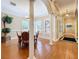 Elegant dining room featuring wood floors, plantation shutters, white columns, and traditional furnishings at 38207 Sabal Way, Umatilla, FL 32784