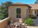 Inviting outdoor seating area complemented by manicured greenery and a beautiful arched window at 38207 Sabal Way, Umatilla, FL 32784