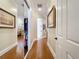 Hallway with hardwood floors, crown moulding, and closet with mirrored doors leading to a bedroom at 38207 Sabal Way, Umatilla, FL 32784