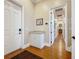 Entryway with hallway featuring wood floors, granite counter, and white cabinets at 38207 Sabal Way, Umatilla, FL 32784