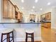 Kitchen bar featuring wood cabinets and dark countertops with two white bar stools at 38207 Sabal Way, Umatilla, FL 32784