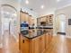 Kitchen island featuring wood cabinets, black countertops, and stainless steel appliances at 38207 Sabal Way, Umatilla, FL 32784