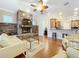 Living room featuring a stone fireplace, breakfast bar with open concept, and hardwood floors at 38207 Sabal Way, Umatilla, FL 32784